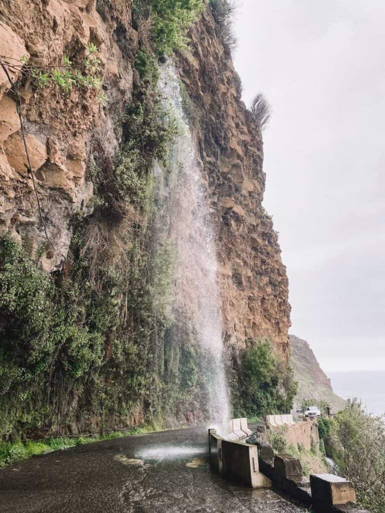 Anjos Waterfall Madeira falls on the road, and it´s a popular spot to drive your car through a waterfall