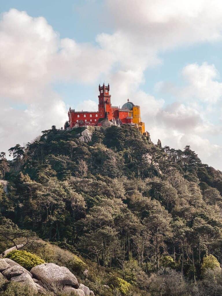 View over the red and yellow Pena Palace from Castelo dos Mouros