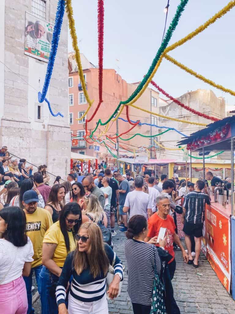 Busy streets with Popular Saints Festival in Portugal. People gather in Alfama Lisbon to party and enjoy a beer and grilled sardines