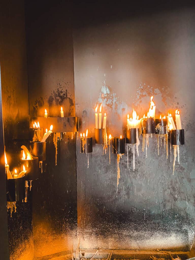 Candles burning inside Capela das Almas or Chapel of souls in Porto