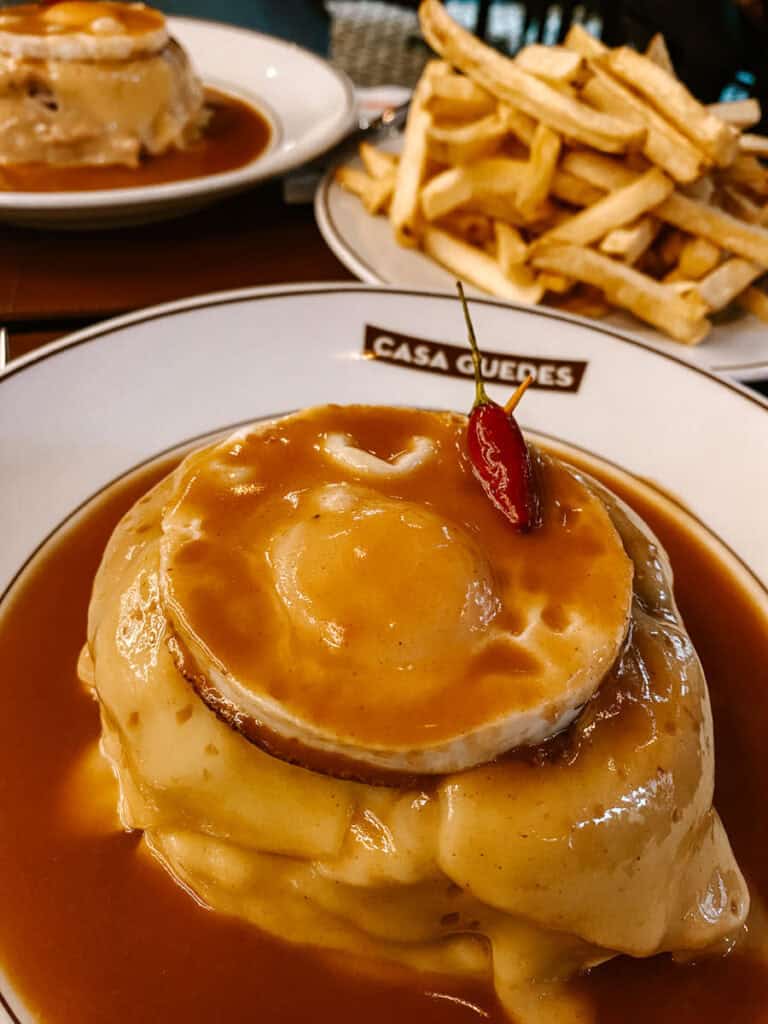 A Francesinha is like a steak sandwich served with an egg on top and melted cheese. It´s surrounded by gravy, like a beer sauce and a side order of fries