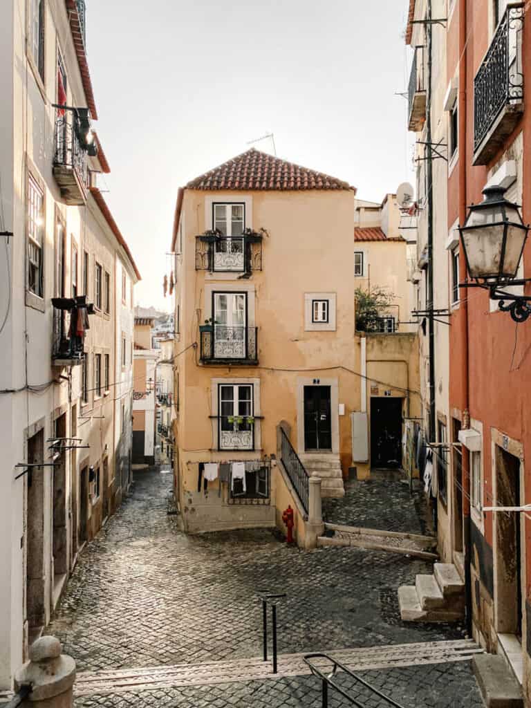 Winter sun in Lisbon in January shining on a yellow house in Alfama